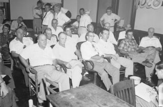 A 1955 Associated Press photo of the jury at the trial of Emmett Till’s killers. Rob F. Hall (with pipe) can be seen taking notes in the press gallery.